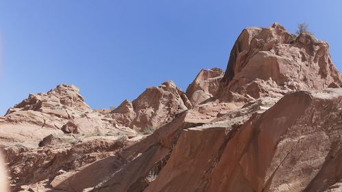 Scenic view of rocky mountains against clear blue sky
