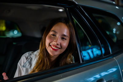 Portrait of young woman in car