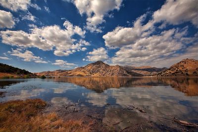 Scenic view of lake against cloudy sky