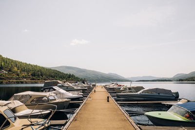 Boats moored in sea against sky