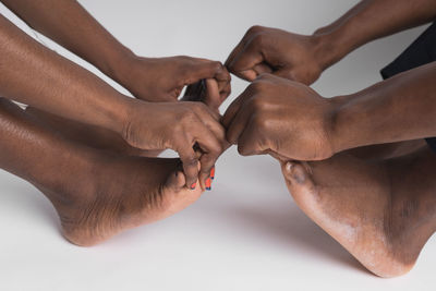 Cropped hand of man with hands on white background