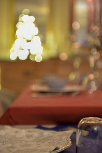 Close-up of illuminated coffee cup on table at home