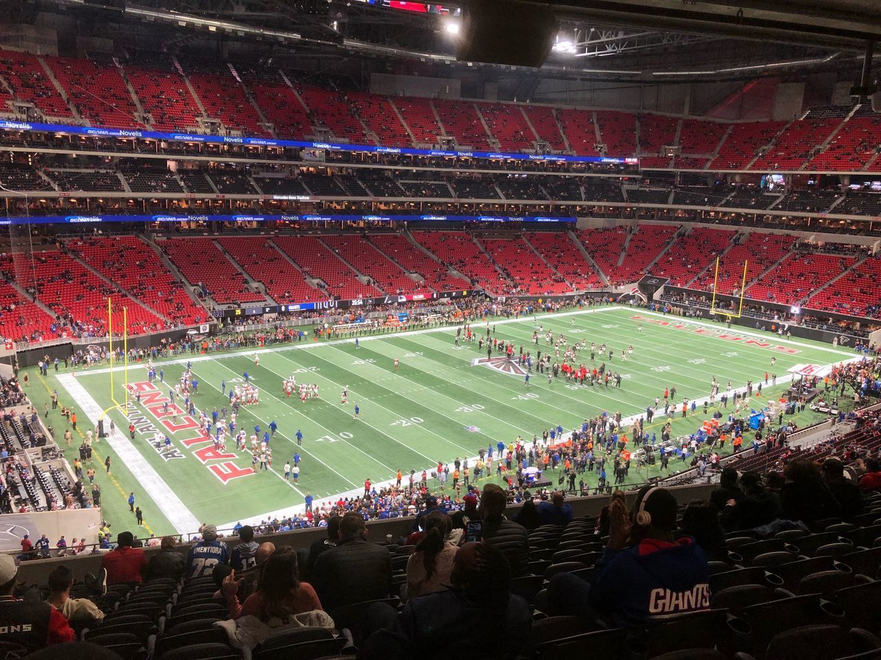 HIGH ANGLE VIEW OF GROUP OF PEOPLE LOOKING AT STADIUM