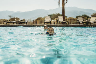 Portrait of man swimming in pool