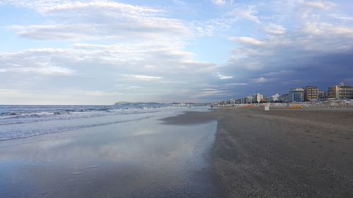 View of beach against cloudy sky