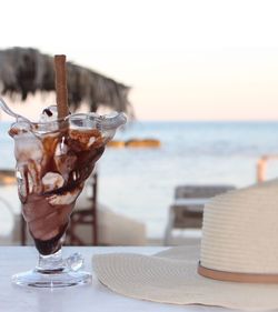 Close-up of dessert on table at beach against sky