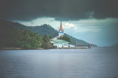 Scenic view of lake by building against sky