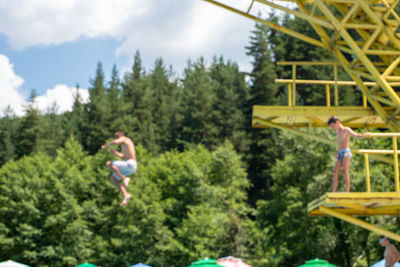 People against trees and plants against sky