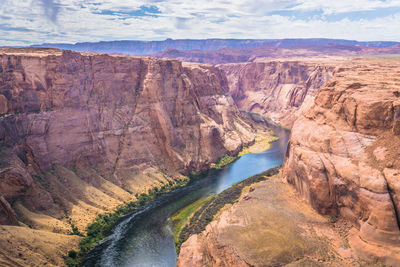 Scenic view of river flowing through mountains