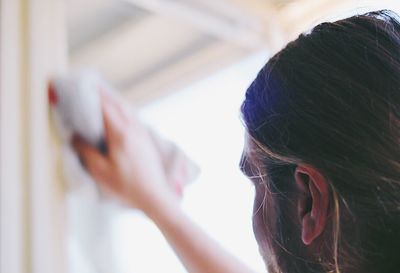 Cropped image of man cleaning window glass