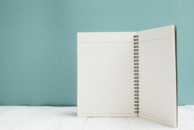 Open book on table against wall