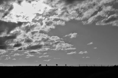 Scenic view of landscape against cloudy sky