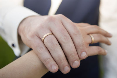 Cropped image of couple holding hands