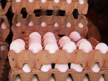 High angle view of white eggs in container