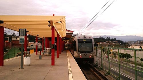 Train at railroad station against sky