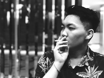 Man smoking cigarette while looking away