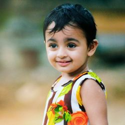 Close-up of child looking away while standing outdoors