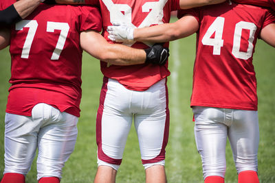 Midsection of player standing on field