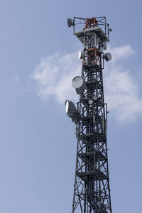 Low angle view of communications tower against sky