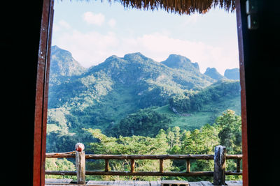 Man looking at view through mountains