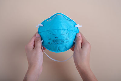 Close-up of human hand against blue background