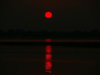 Scenic view of river against sky at night