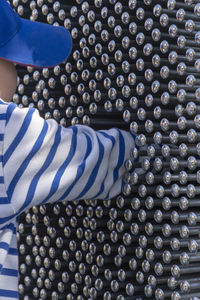 Cropped image of boy playing with metallic equipment