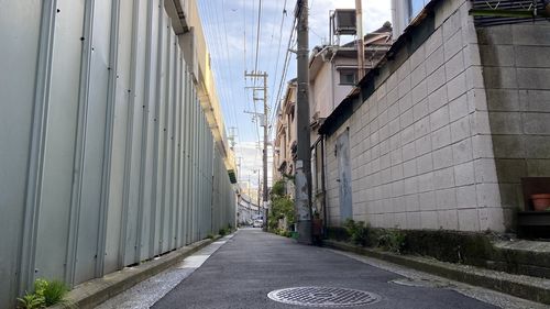 Empty alley amidst buildings in city