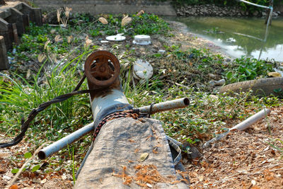 High angle view of old pipe on field