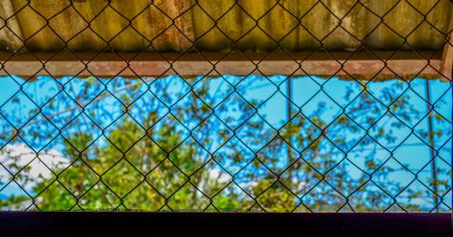 Chainlink fence against blue sky