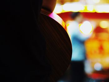 Close-up of woman standing at night