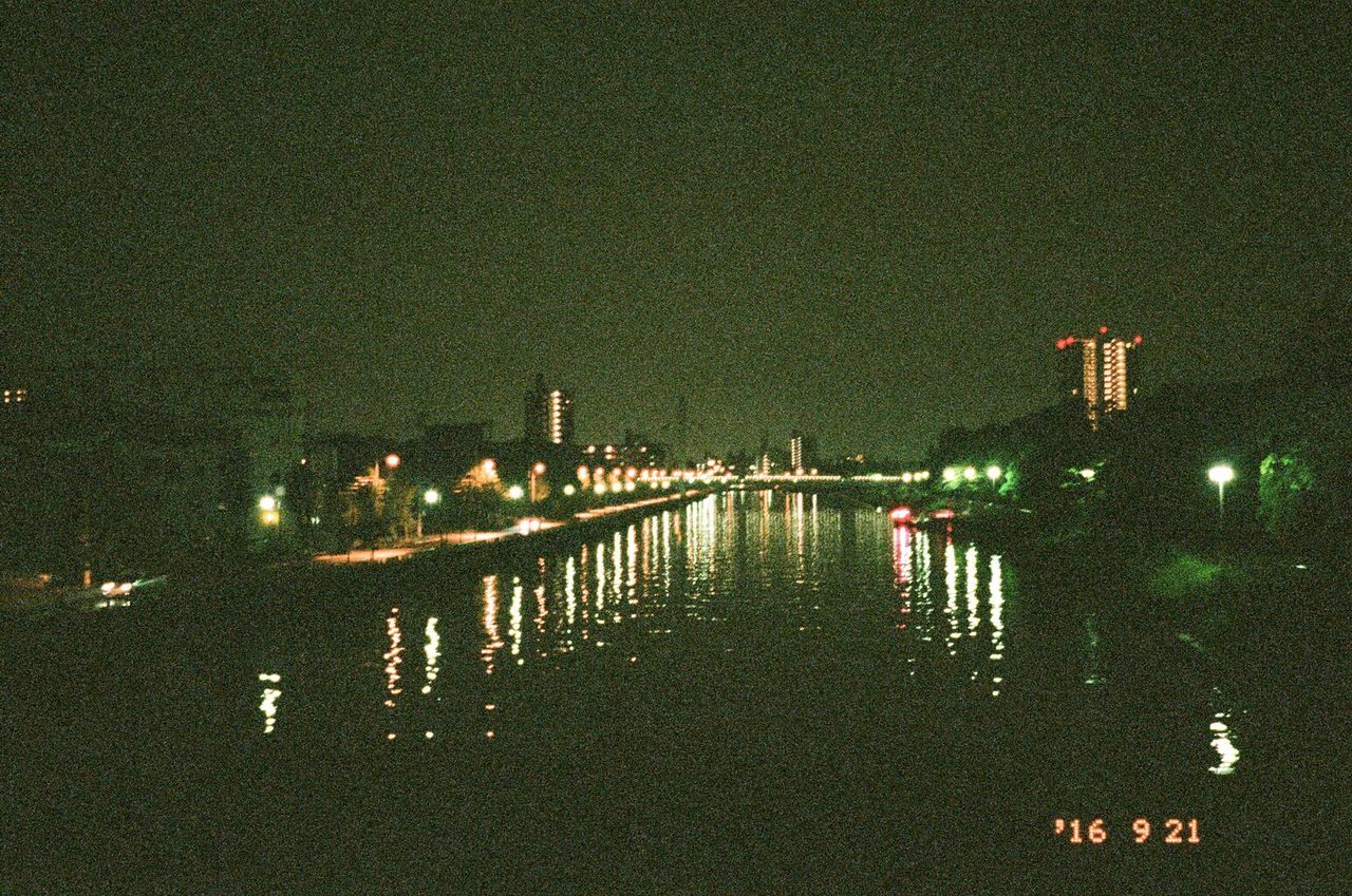 ILLUMINATED BRIDGE OVER WATER