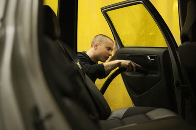 Man cleaning car door in carwash