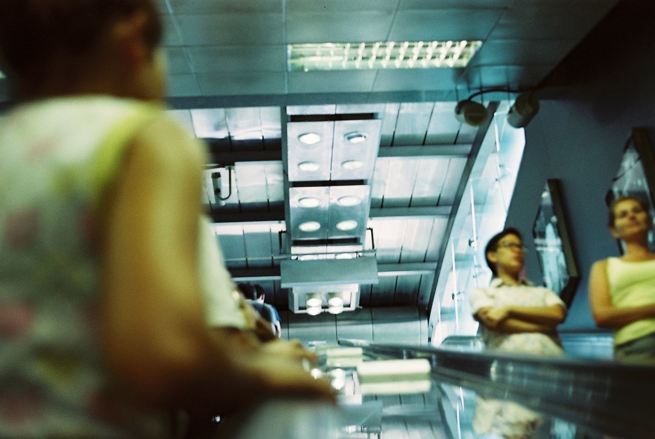 REAR VIEW OF PEOPLE WORKING IN KITCHEN