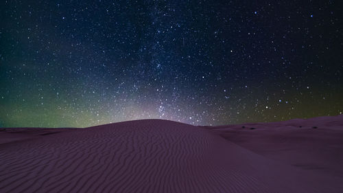 Scenic view of desert against sky at night