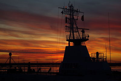 Ship anchored by river at dusk