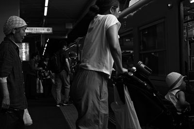 Rear view of people standing at bus