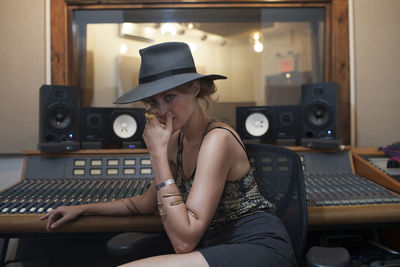 Portrait of a young woman in a recording studio