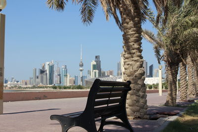 Chairs and tables by buildings against clear sky