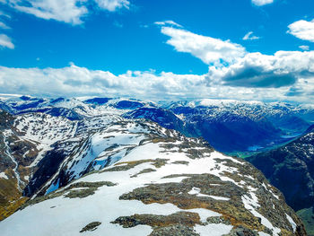 Scenic view of snowcapped mountains against blue sky