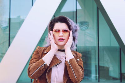 Portrait of woman wearing sunglasses in city