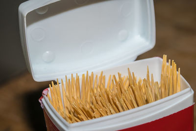 Close-up of toothpicks in plastic container