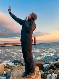 Rear view of man standing at beach