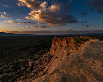 Scenic view of rocky landscape against sky during sunset