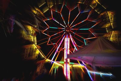 Illuminated ferris wheel at night