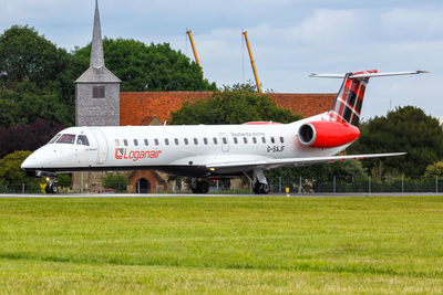 Airplane on field against sky