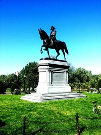 Low angle view of statue against clear blue sky