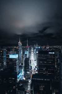 Illuminated cityscape against sky at night