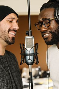 Happy singers singing in studio