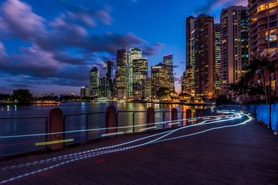 Illuminated buildings against sky at night